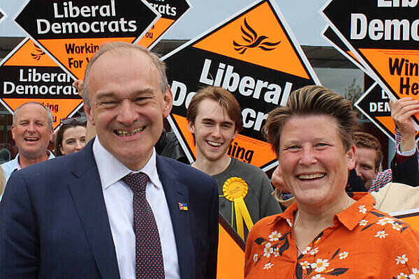 Election campaigners holding yellow placards, with candidate Sarah Dyke and Leader in the foreground