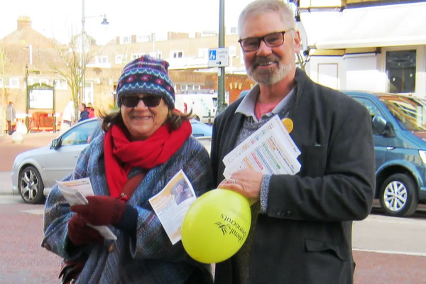 Leafletting - two persons delivering campaign leaflets